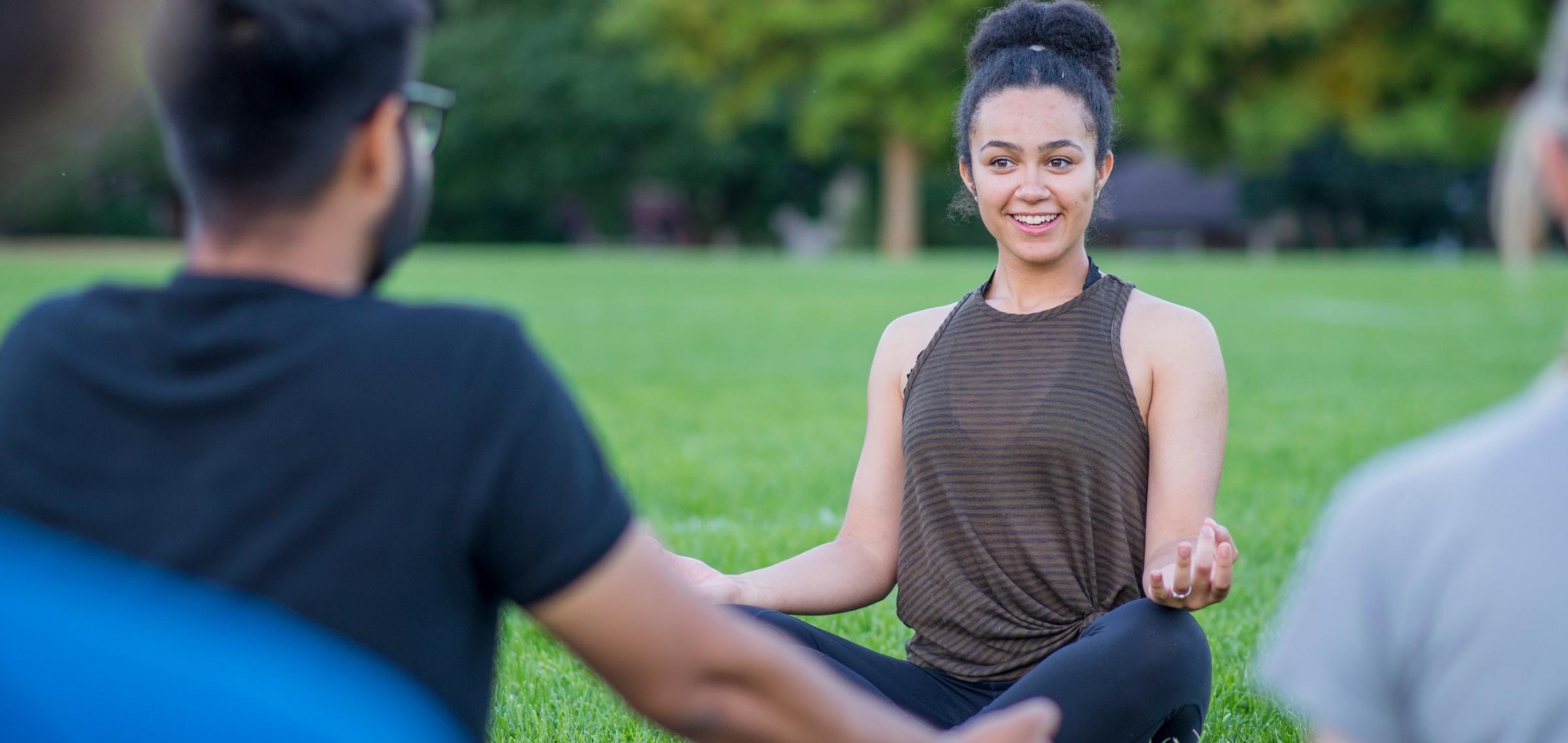 Yogalehrerin beim Outdoor Yoga im Park